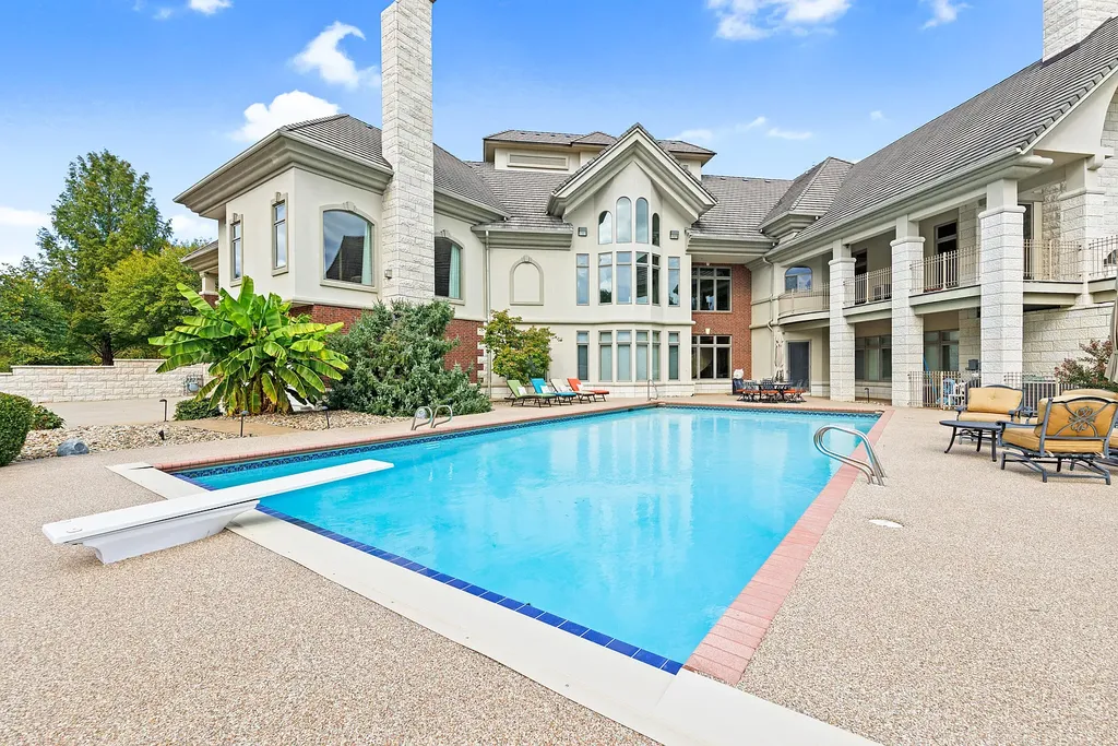 6800 S Lakota Ridge Lane Home in Columbia, Missouri. Discover the epitome of luxury living in this one-of-a-kind 11,000 square foot estate in southern Columbia. Boasting imported Israeli stone, soaring 28-foot ceilings, alabaster light fixtures, heated floors, and a stunning 30-foot waterfall, this home is truly extraordinary. 