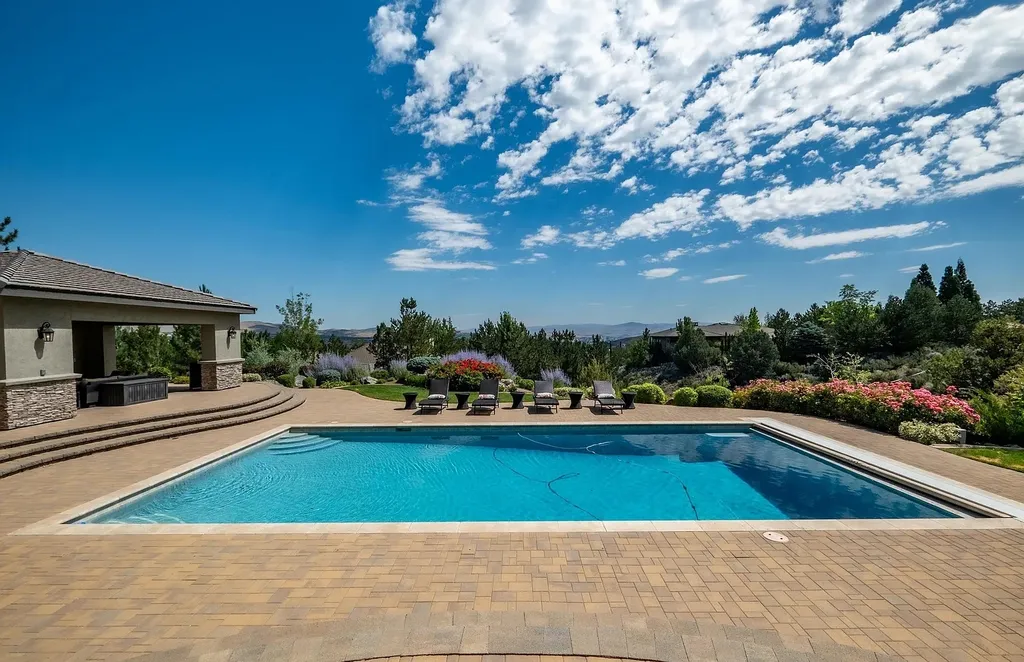 Discover the exquisite luxury of Eagle's Nest, a unique and meticulously designed estate in the prestigious gated community. Enjoy panoramic views, soaring ceilings, and a perfect blend of modern comfort and timeless elegance. This magnificent property features a chef's kitchen, a wine cellar, a resort-style pool area, and much more. 