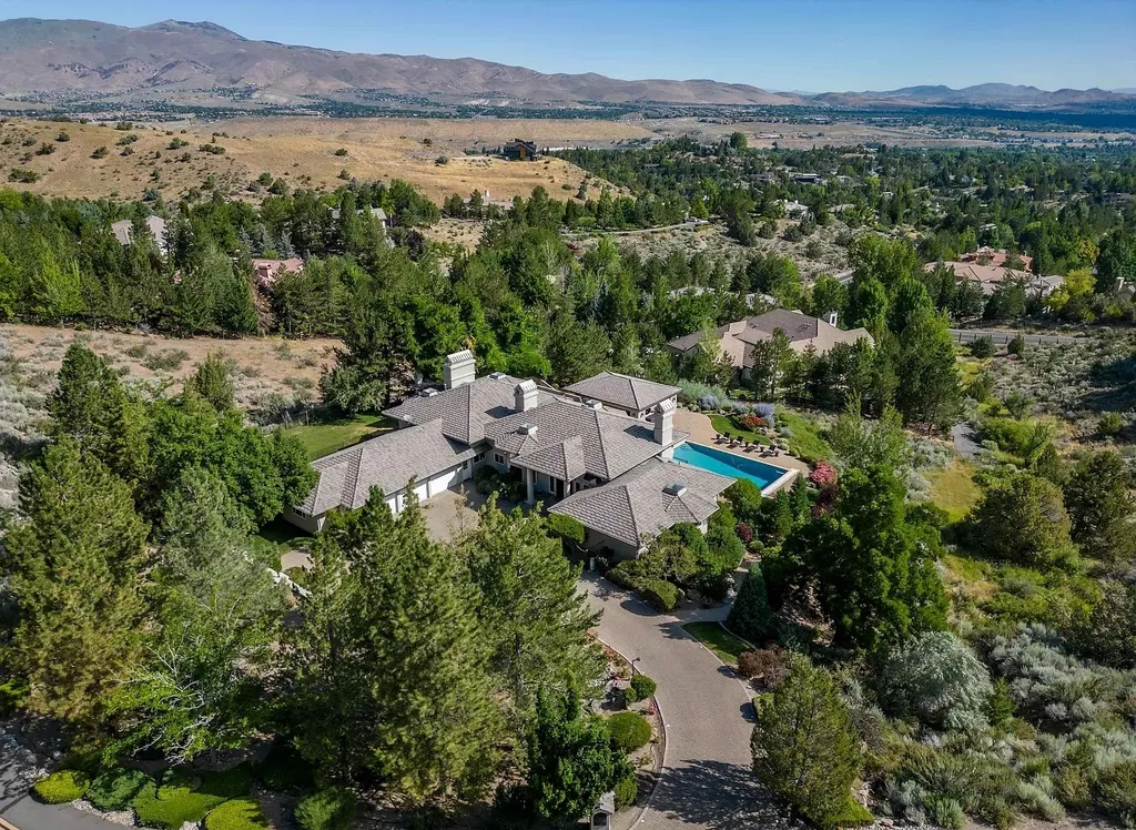 Discover the exquisite luxury of Eagle's Nest, a unique and meticulously designed estate in the prestigious gated community. Enjoy panoramic views, soaring ceilings, and a perfect blend of modern comfort and timeless elegance. This magnificent property features a chef's kitchen, a wine cellar, a resort-style pool area, and much more. 