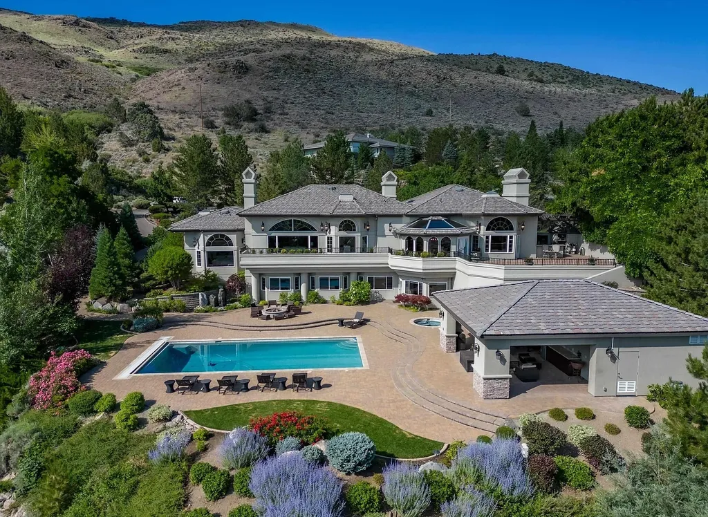 Discover the exquisite luxury of Eagle's Nest, a unique and meticulously designed estate in the prestigious gated community. Enjoy panoramic views, soaring ceilings, and a perfect blend of modern comfort and timeless elegance. This magnificent property features a chef's kitchen, a wine cellar, a resort-style pool area, and much more. 