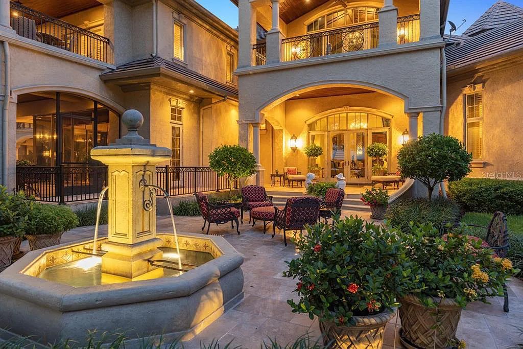 Discover elegance and luxury at 5200 Isleworth Country Club Drive in Windermere, Florida. This magnificent 5-bed, 8-bath estate with 9,482 sq ft of living space is situated on the eighth fairway of the Isleworth Golf and Country Club golf course, offering breathtaking views of Lake Bessie