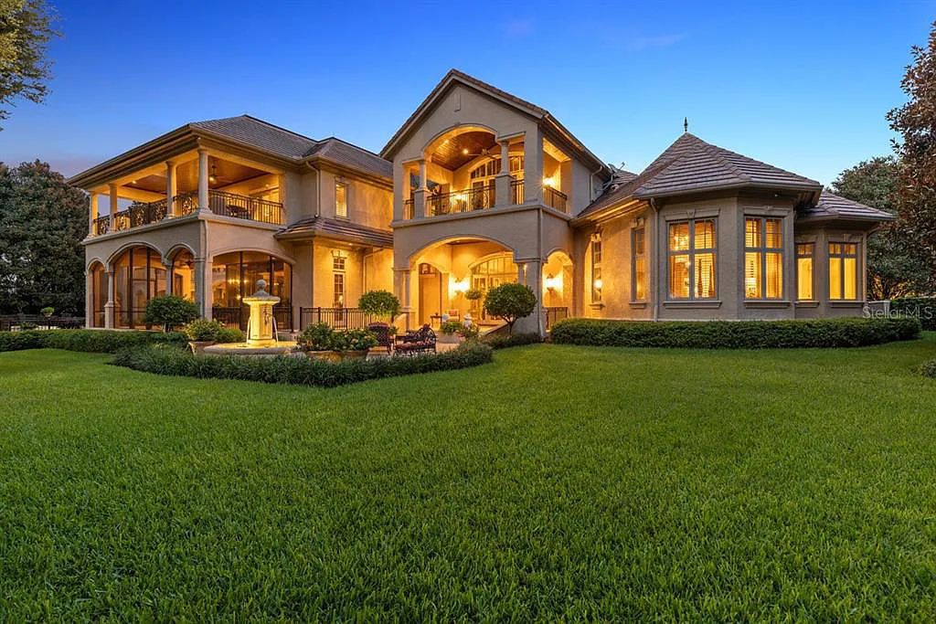 Discover elegance and luxury at 5200 Isleworth Country Club Drive in Windermere, Florida. This magnificent 5-bed, 8-bath estate with 9,482 sq ft of living space is situated on the eighth fairway of the Isleworth Golf and Country Club golf course, offering breathtaking views of Lake Bessie