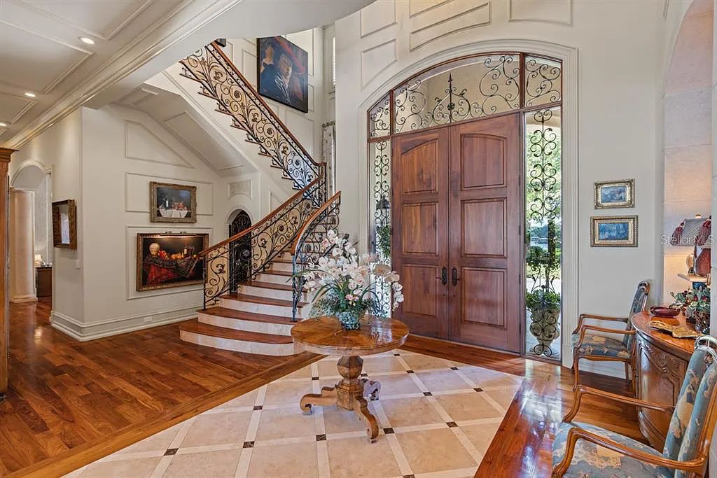 Discover elegance and luxury at 5200 Isleworth Country Club Drive in Windermere, Florida. This magnificent 5-bed, 8-bath estate with 9,482 sq ft of living space is situated on the eighth fairway of the Isleworth Golf and Country Club golf course, offering breathtaking views of Lake Bessie