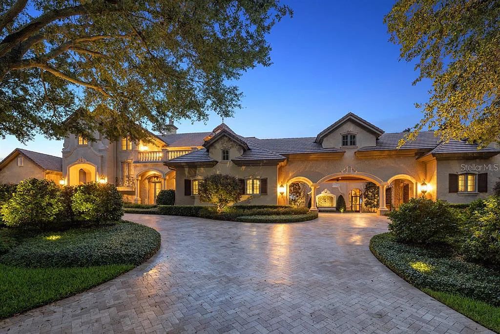 Discover elegance and luxury at 5200 Isleworth Country Club Drive in Windermere, Florida. This magnificent 5-bed, 8-bath estate with 9,482 sq ft of living space is situated on the eighth fairway of the Isleworth Golf and Country Club golf course, offering breathtaking views of Lake Bessie