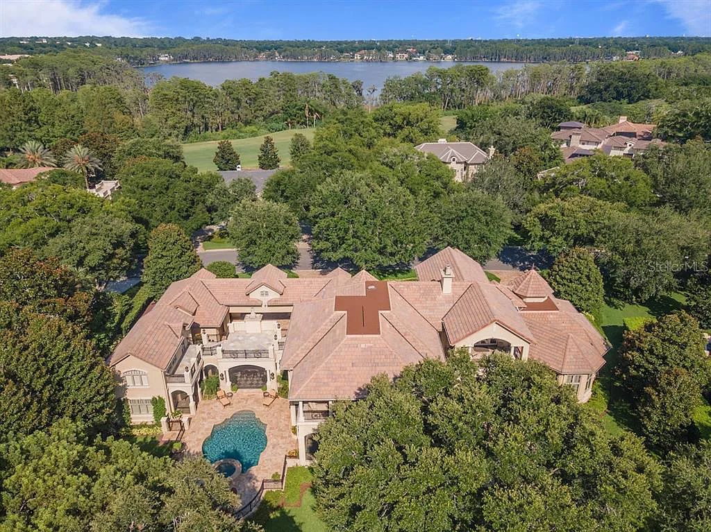 Discover elegance and luxury at 5200 Isleworth Country Club Drive in Windermere, Florida. This magnificent 5-bed, 8-bath estate with 9,482 sq ft of living space is situated on the eighth fairway of the Isleworth Golf and Country Club golf course, offering breathtaking views of Lake Bessie