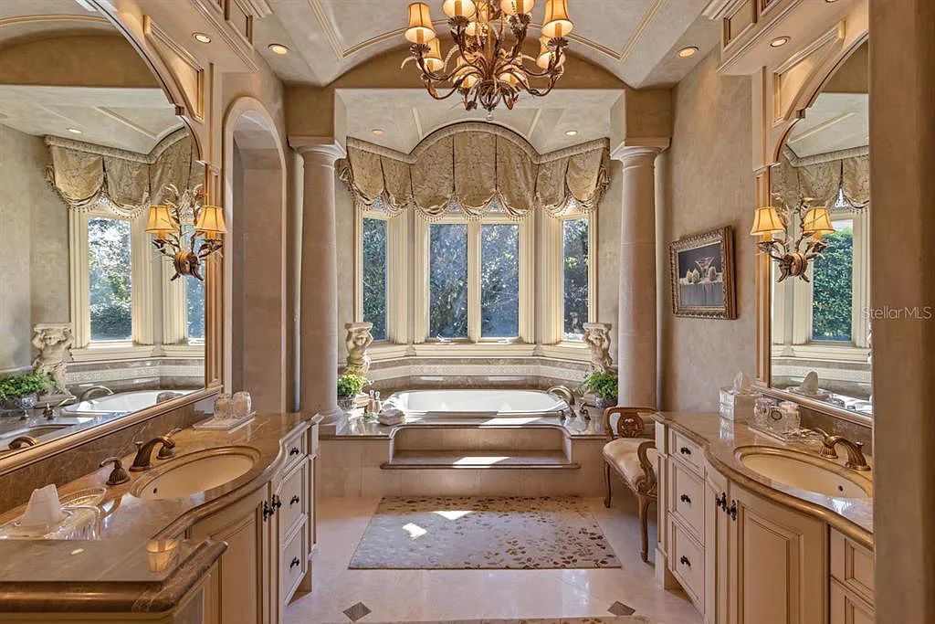 Discover elegance and luxury at 5200 Isleworth Country Club Drive in Windermere, Florida. This magnificent 5-bed, 8-bath estate with 9,482 sq ft of living space is situated on the eighth fairway of the Isleworth Golf and Country Club golf course, offering breathtaking views of Lake Bessie