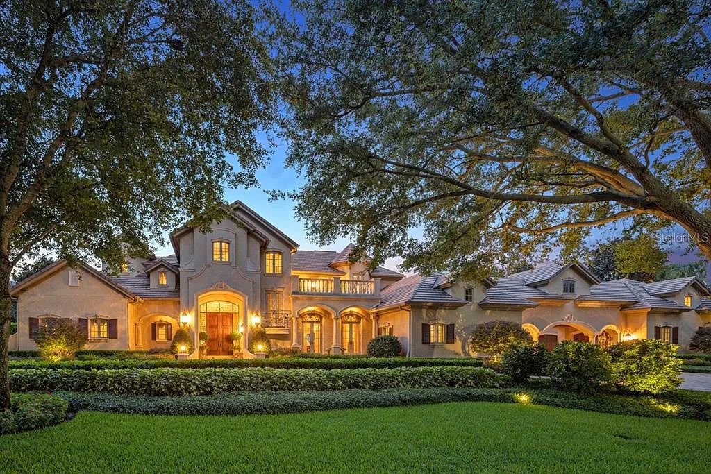 Discover elegance and luxury at 5200 Isleworth Country Club Drive in Windermere, Florida. This magnificent 5-bed, 8-bath estate with 9,482 sq ft of living space is situated on the eighth fairway of the Isleworth Golf and Country Club golf course, offering breathtaking views of Lake Bessie
