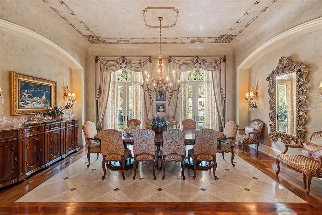 Discover elegance and luxury at 5200 Isleworth Country Club Drive in Windermere, Florida. This magnificent 5-bed, 8-bath estate with 9,482 sq ft of living space is situated on the eighth fairway of the Isleworth Golf and Country Club golf course, offering breathtaking views of Lake Bessie
