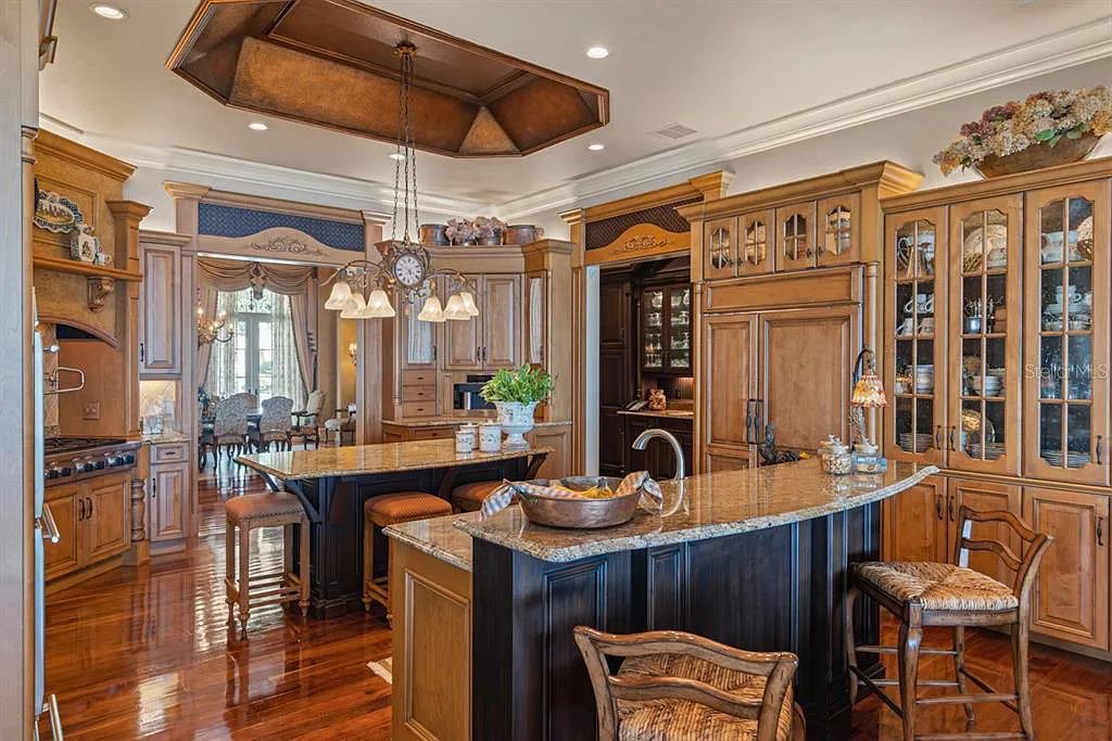 Discover elegance and luxury at 5200 Isleworth Country Club Drive in Windermere, Florida. This magnificent 5-bed, 8-bath estate with 9,482 sq ft of living space is situated on the eighth fairway of the Isleworth Golf and Country Club golf course, offering breathtaking views of Lake Bessie