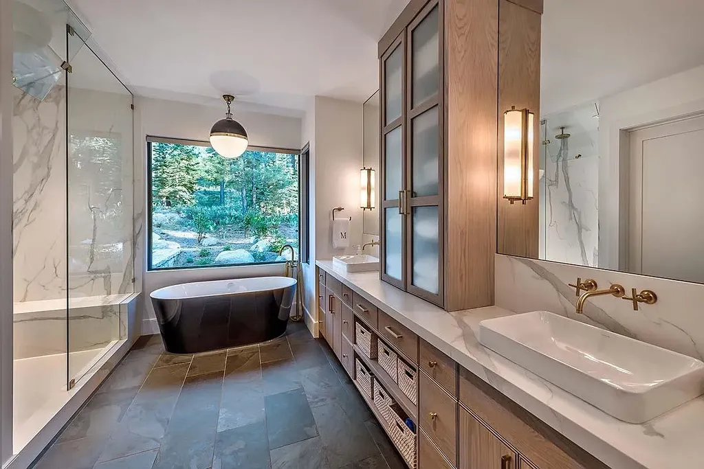 9601 Dunsmuir Way Home in Truckee, California. Immerse yourself in the tranquility of this exquisite Martis Camp home, boasting panoramic mountain views and luxurious amenities. Wake up to breathtaking sunrises, enjoy the open great room with its stunning architecture, and indulge in the state-of-the-art kitchen and spacious living areas. With five bedrooms, a hot tub patio, and proximity to skiing and tennis facilities, this retreat offers a perfect balance of serenity and convenience. Experience mountain living at its finest in this stylishly designed home nestled amidst the natural beauty of Martis Camp.