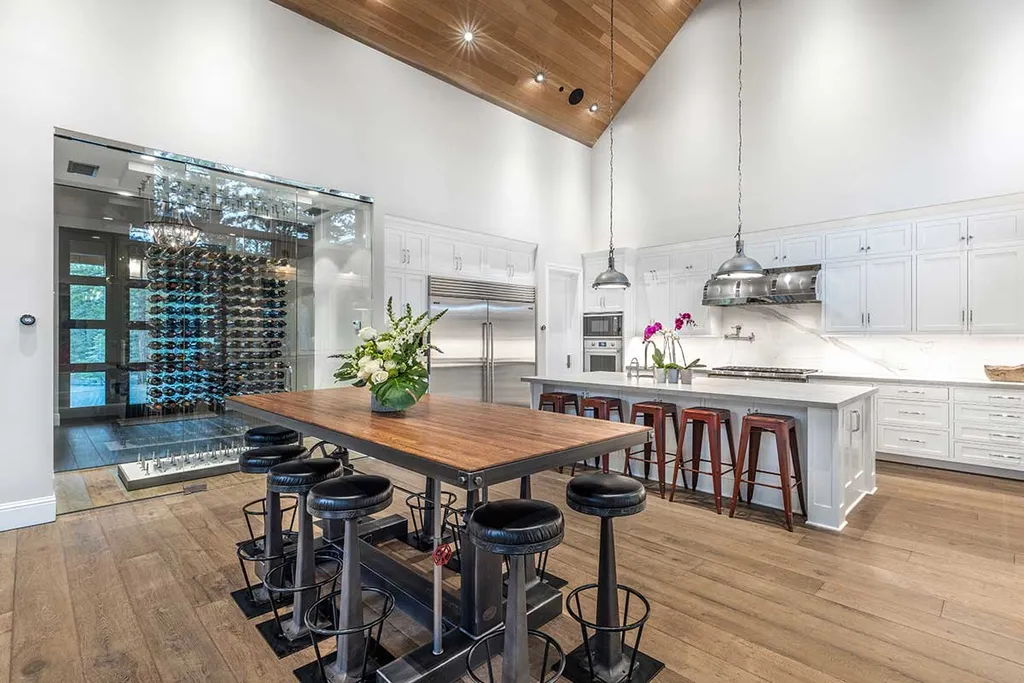 9661 Dunsmuir Way Home in Truckee, California. Prepare to be captivated as you step through the front door of this extraordinary 7,546-square-foot modern mountain home in Martis Camp. The first glimpse is nothing short of awe-inspiring—a vast expanse of glass that serves as both a wall and a stunning 288-bottle wine cellar. This artistic flair extends throughout the 6-bedroom, 7-bathroom residence, creating a truly unique and rewarding living experience.