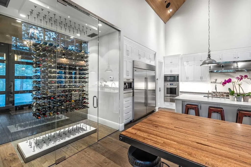 9661 Dunsmuir Way Home in Truckee, California. Prepare to be captivated as you step through the front door of this extraordinary 7,546-square-foot modern mountain home in Martis Camp. The first glimpse is nothing short of awe-inspiring—a vast expanse of glass that serves as both a wall and a stunning 288-bottle wine cellar. This artistic flair extends throughout the 6-bedroom, 7-bathroom residence, creating a truly unique and rewarding living experience.