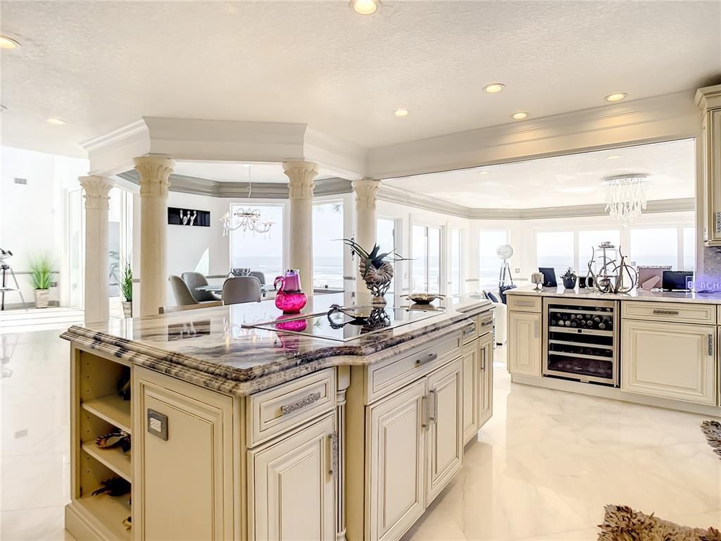 Welcome to 4031 S Atlantic Avenue in Port Orange, Florida - an exquisite beachfront property boasting breathtaking ocean views and a fully renovated design. This gated home offers over 5,300 square feet of living space, featuring 6 bedrooms, 5.5 bathrooms, and an attached in-law suite.