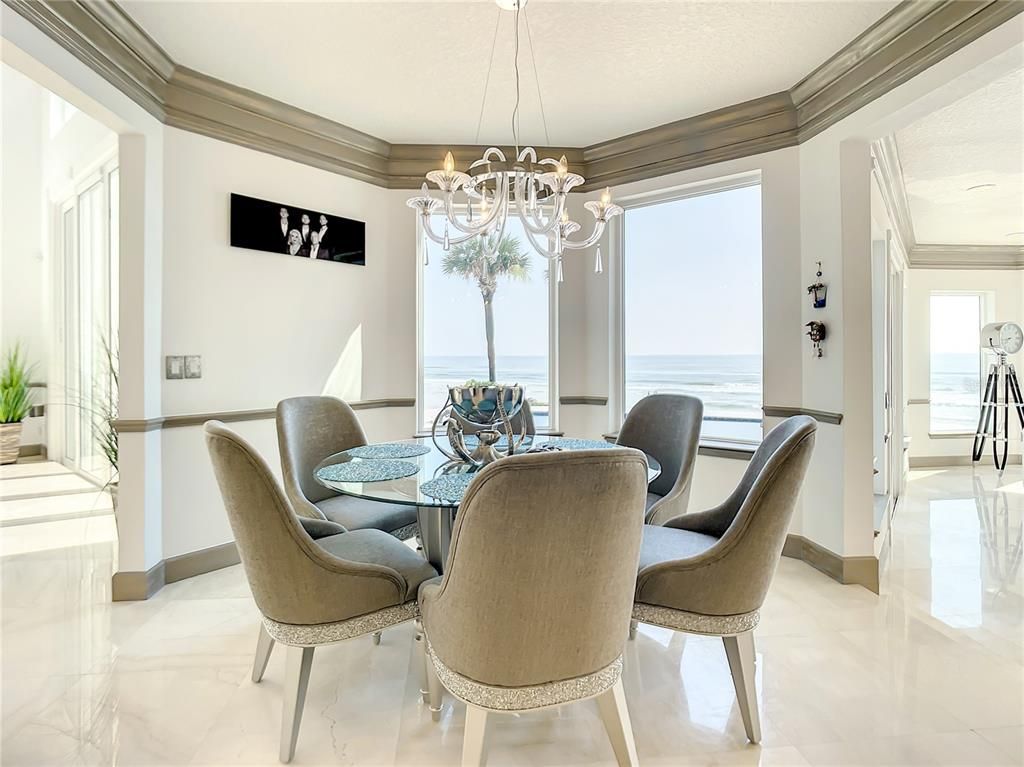 Welcome to 4031 S Atlantic Avenue in Port Orange, Florida - an exquisite beachfront property boasting breathtaking ocean views and a fully renovated design. This gated home offers over 5,300 square feet of living space, featuring 6 bedrooms, 5.5 bathrooms, and an attached in-law suite.