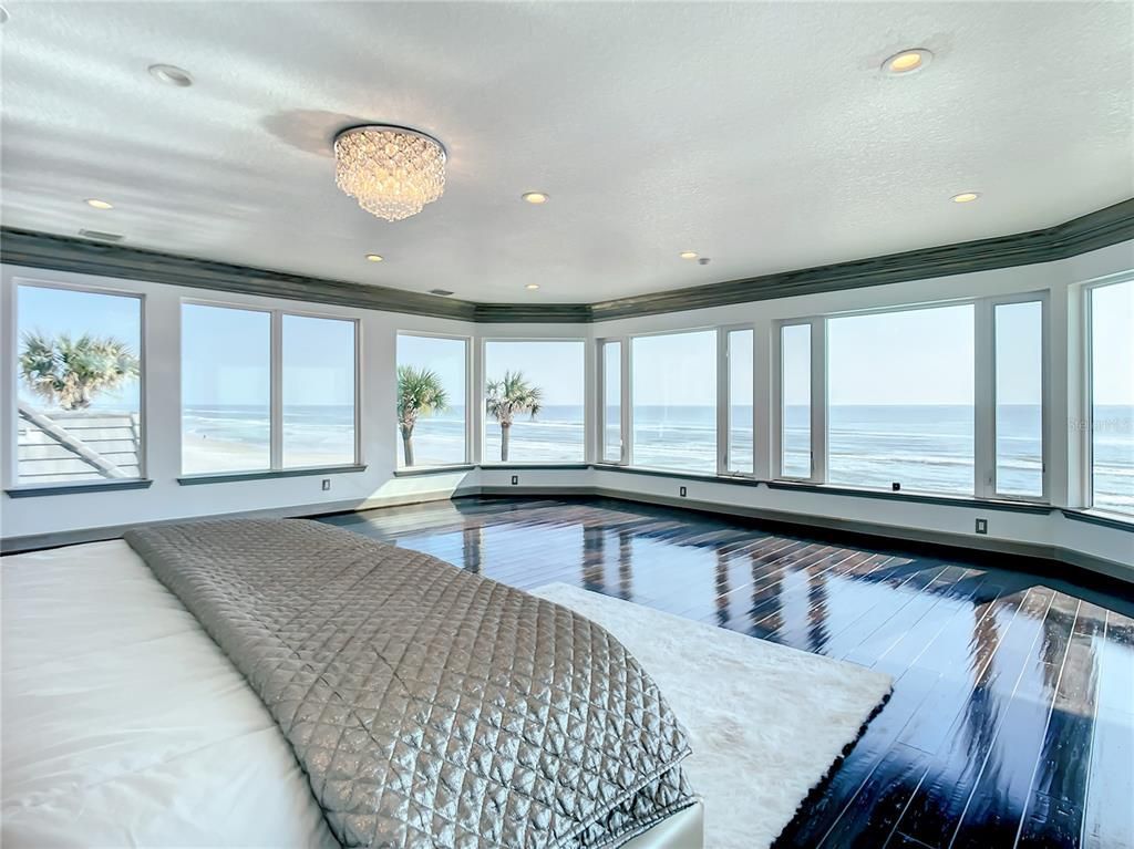 Welcome to 4031 S Atlantic Avenue in Port Orange, Florida - an exquisite beachfront property boasting breathtaking ocean views and a fully renovated design. This gated home offers over 5,300 square feet of living space, featuring 6 bedrooms, 5.5 bathrooms, and an attached in-law suite.