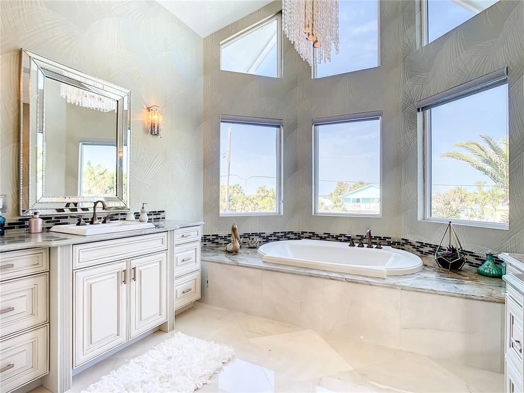Welcome to 4031 S Atlantic Avenue in Port Orange, Florida - an exquisite beachfront property boasting breathtaking ocean views and a fully renovated design. This gated home offers over 5,300 square feet of living space, featuring 6 bedrooms, 5.5 bathrooms, and an attached in-law suite.