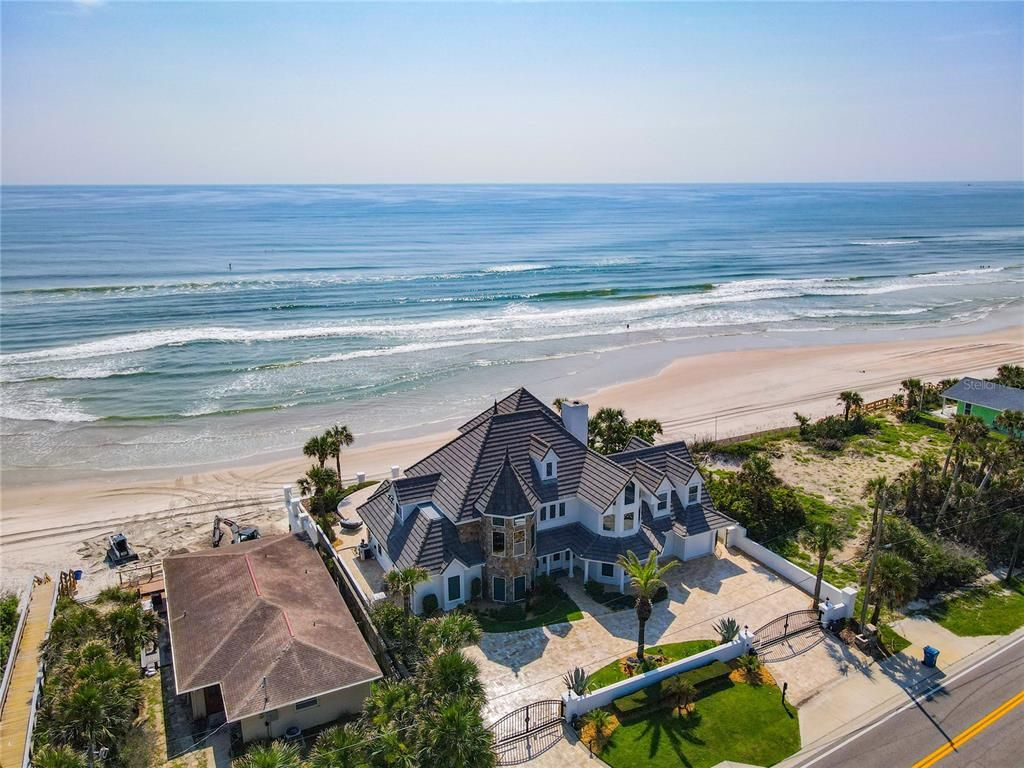 Welcome to 4031 S Atlantic Avenue in Port Orange, Florida - an exquisite beachfront property boasting breathtaking ocean views and a fully renovated design. This gated home offers over 5,300 square feet of living space, featuring 6 bedrooms, 5.5 bathrooms, and an attached in-law suite.