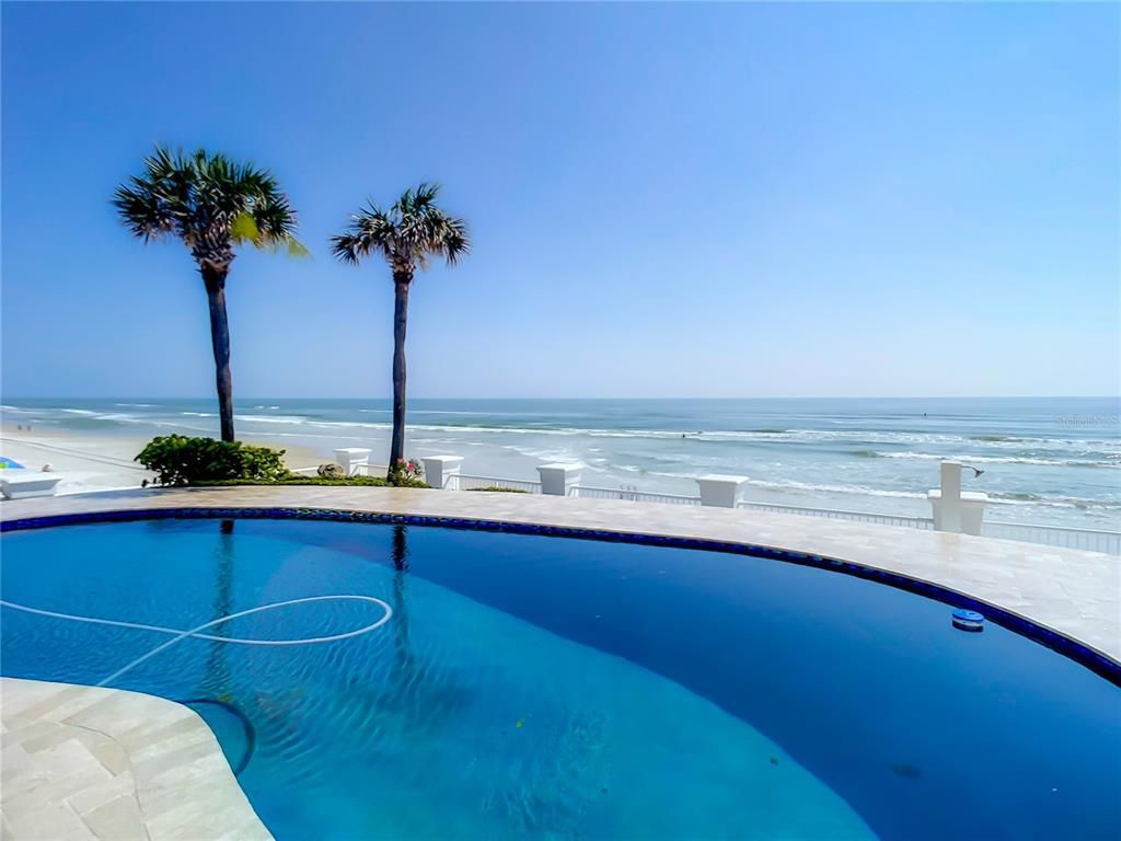 Welcome to 4031 S Atlantic Avenue in Port Orange, Florida - an exquisite beachfront property boasting breathtaking ocean views and a fully renovated design. This gated home offers over 5,300 square feet of living space, featuring 6 bedrooms, 5.5 bathrooms, and an attached in-law suite.