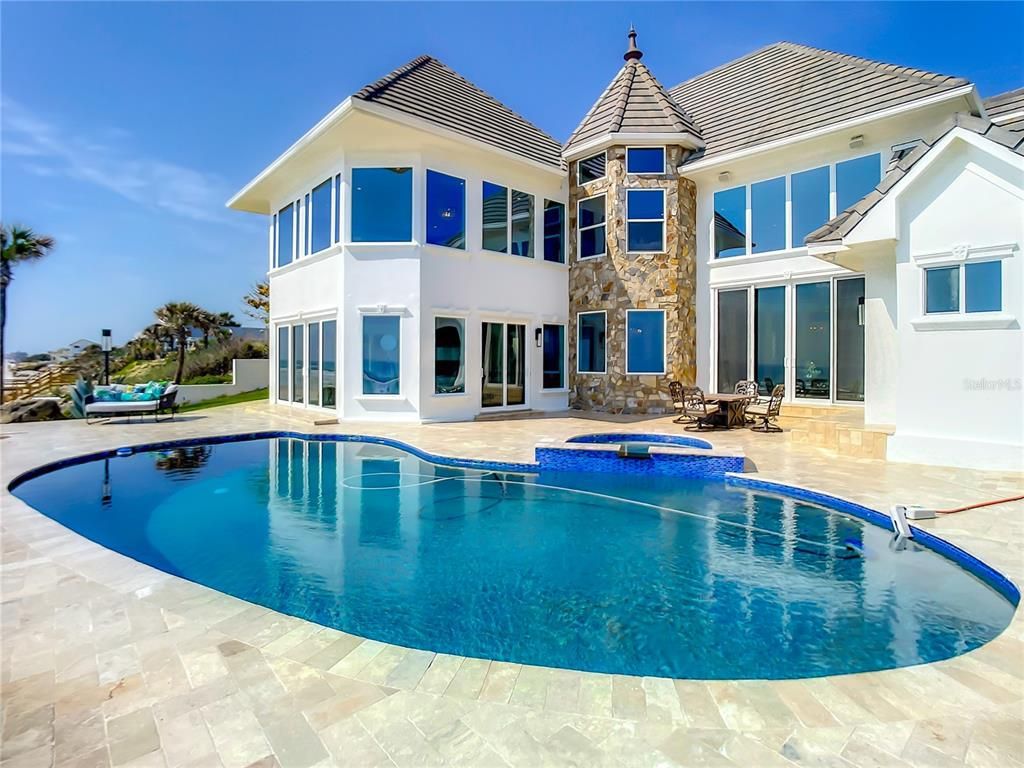 Welcome to 4031 S Atlantic Avenue in Port Orange, Florida - an exquisite beachfront property boasting breathtaking ocean views and a fully renovated design. This gated home offers over 5,300 square feet of living space, featuring 6 bedrooms, 5.5 bathrooms, and an attached in-law suite.