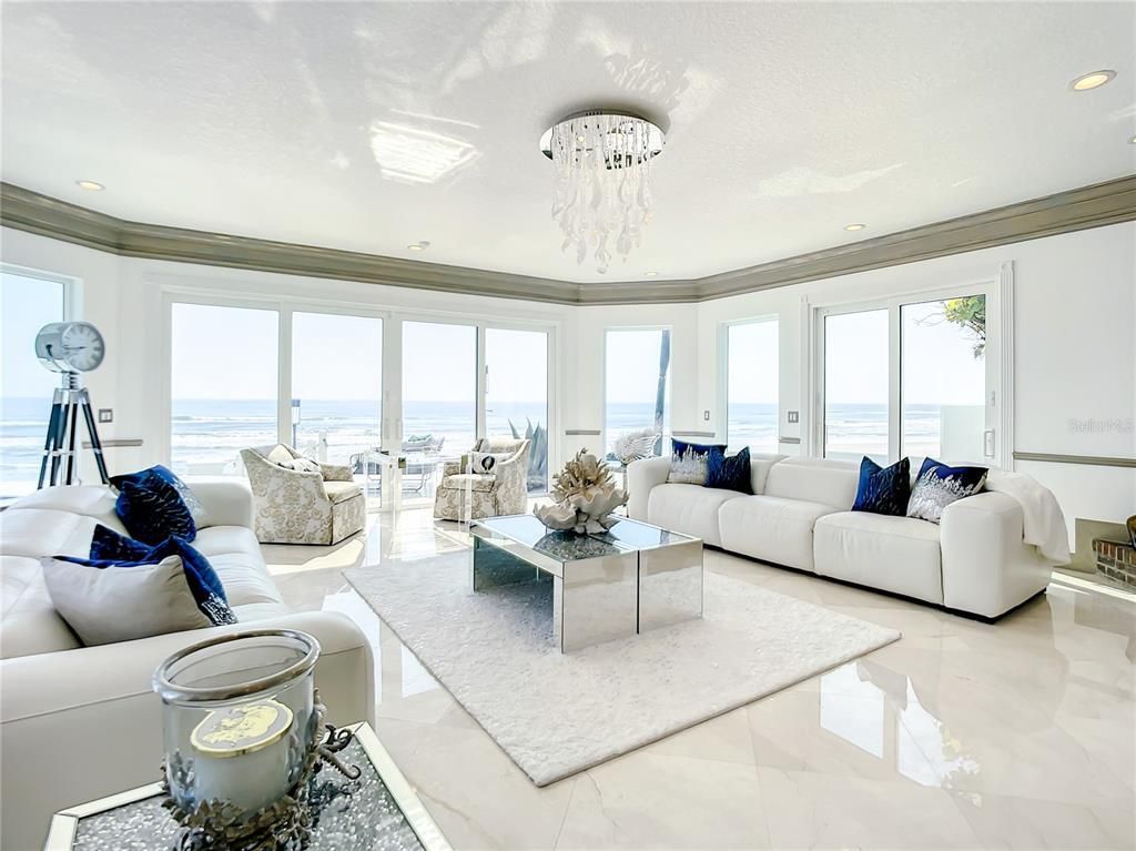 Welcome to 4031 S Atlantic Avenue in Port Orange, Florida - an exquisite beachfront property boasting breathtaking ocean views and a fully renovated design. This gated home offers over 5,300 square feet of living space, featuring 6 bedrooms, 5.5 bathrooms, and an attached in-law suite.
