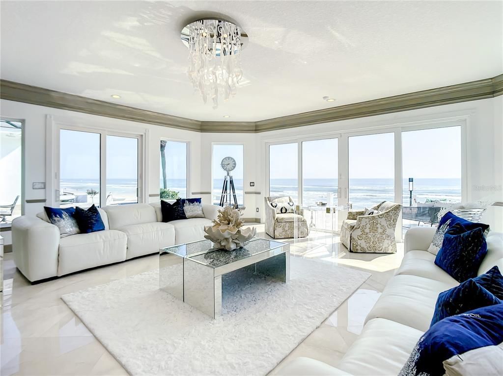 Welcome to 4031 S Atlantic Avenue in Port Orange, Florida - an exquisite beachfront property boasting breathtaking ocean views and a fully renovated design. This gated home offers over 5,300 square feet of living space, featuring 6 bedrooms, 5.5 bathrooms, and an attached in-law suite.