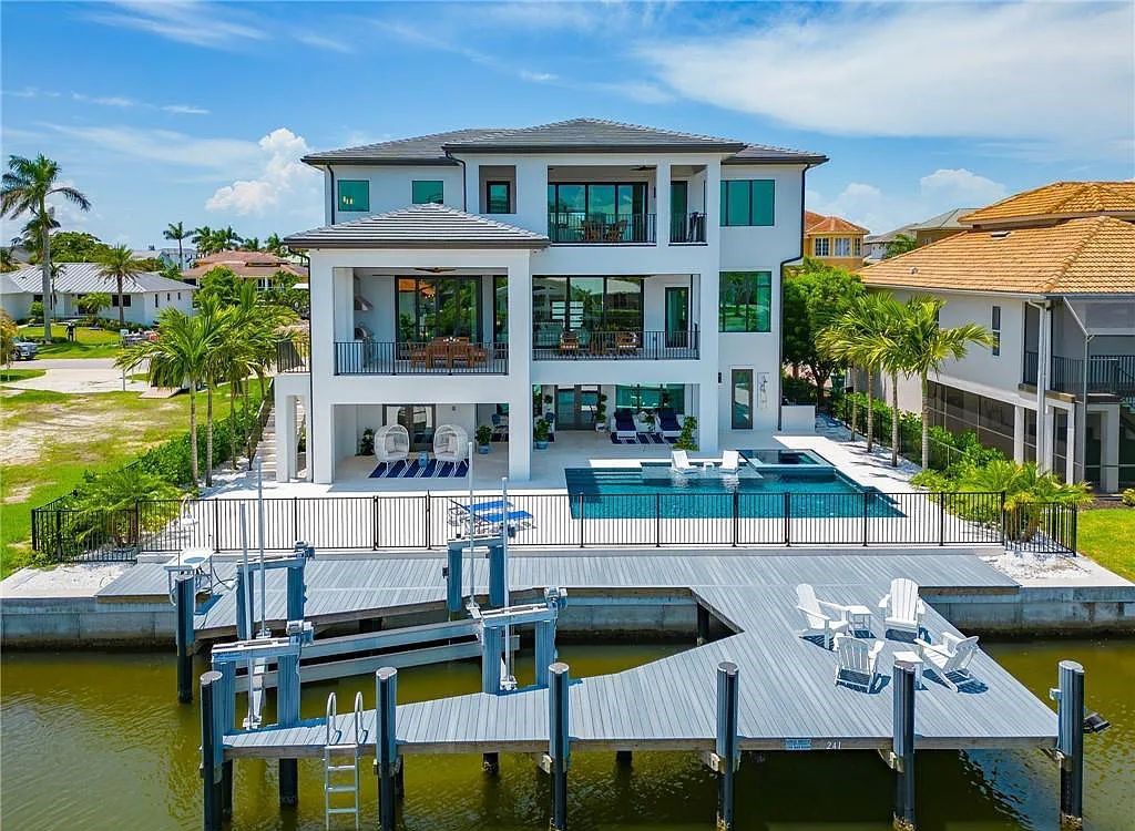 Experience the epitome of luxury living at 241 Egret Avenue, an impressive waterfront gulf access home in Naples, Florida. This newly built three-story residence boasts 5 bedrooms, 7 baths, and a wealth of upscale features.