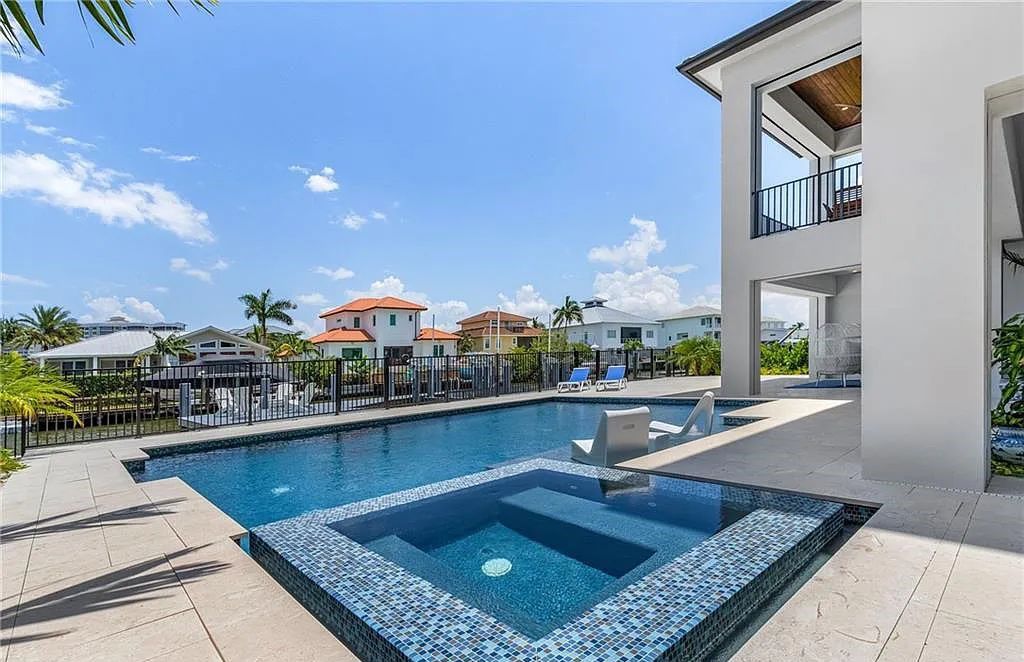 Experience the epitome of luxury living at 241 Egret Avenue, an impressive waterfront gulf access home in Naples, Florida. This newly built three-story residence boasts 5 bedrooms, 7 baths, and a wealth of upscale features.