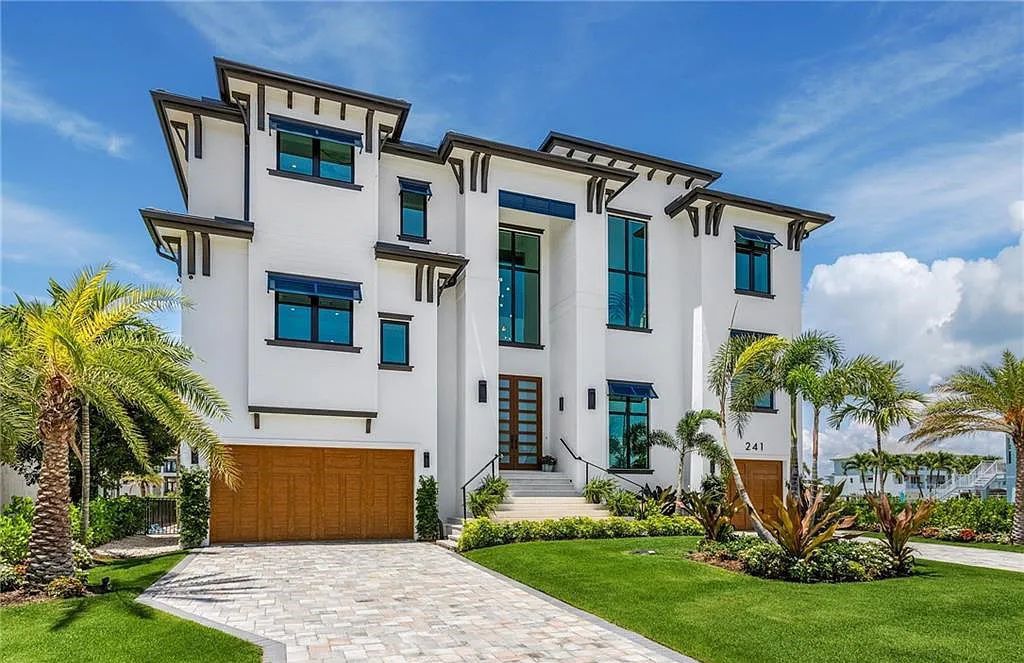 Experience the epitome of luxury living at 241 Egret Avenue, an impressive waterfront gulf access home in Naples, Florida. This newly built three-story residence boasts 5 bedrooms, 7 baths, and a wealth of upscale features.