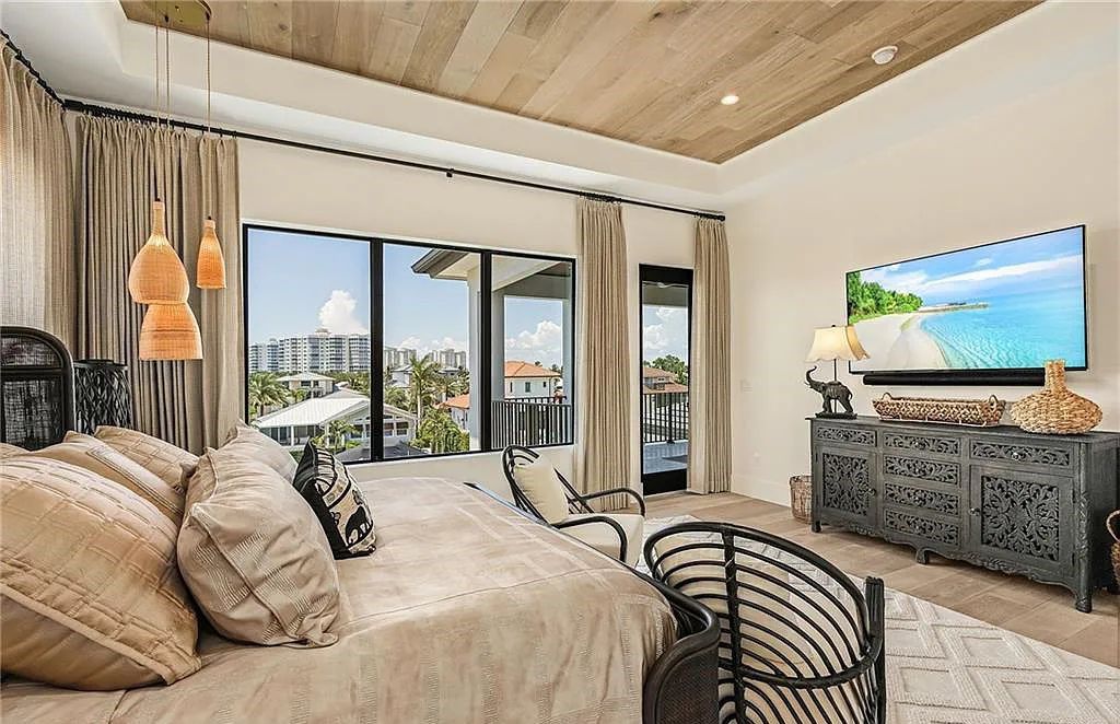 Experience the epitome of luxury living at 241 Egret Avenue, an impressive waterfront gulf access home in Naples, Florida. This newly built three-story residence boasts 5 bedrooms, 7 baths, and a wealth of upscale features.