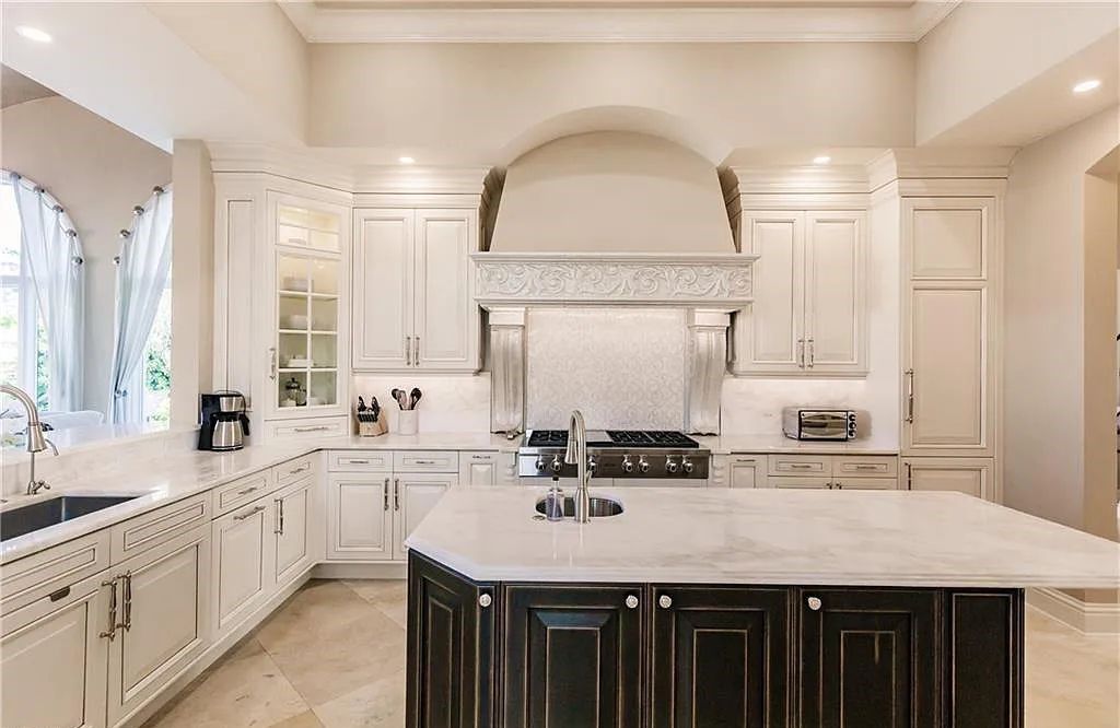 Discover the ultimate Naples, Florida retreat at 2450 Tarpon Road, "The Gateway to Naples Bay." This exceptional property offers a luxurious 4+den/4.5 bath home with 4,450 square feet of living space, recently re-decorated and furnished by Clive Daniel