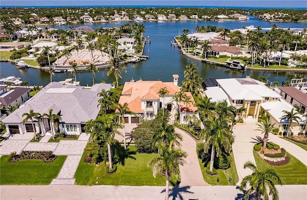 Discover the ultimate Naples, Florida retreat at 2450 Tarpon Road, "The Gateway to Naples Bay." This exceptional property offers a luxurious 4+den/4.5 bath home with 4,450 square feet of living space, recently re-decorated and furnished by Clive Daniel
