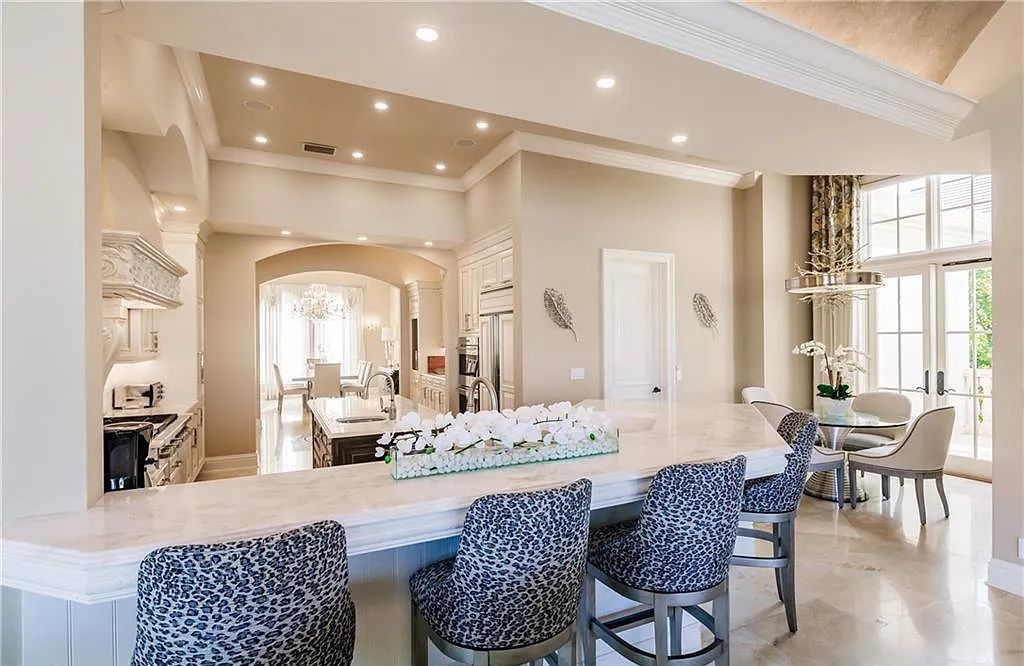 Discover the ultimate Naples, Florida retreat at 2450 Tarpon Road, "The Gateway to Naples Bay." This exceptional property offers a luxurious 4+den/4.5 bath home with 4,450 square feet of living space, recently re-decorated and furnished by Clive Daniel