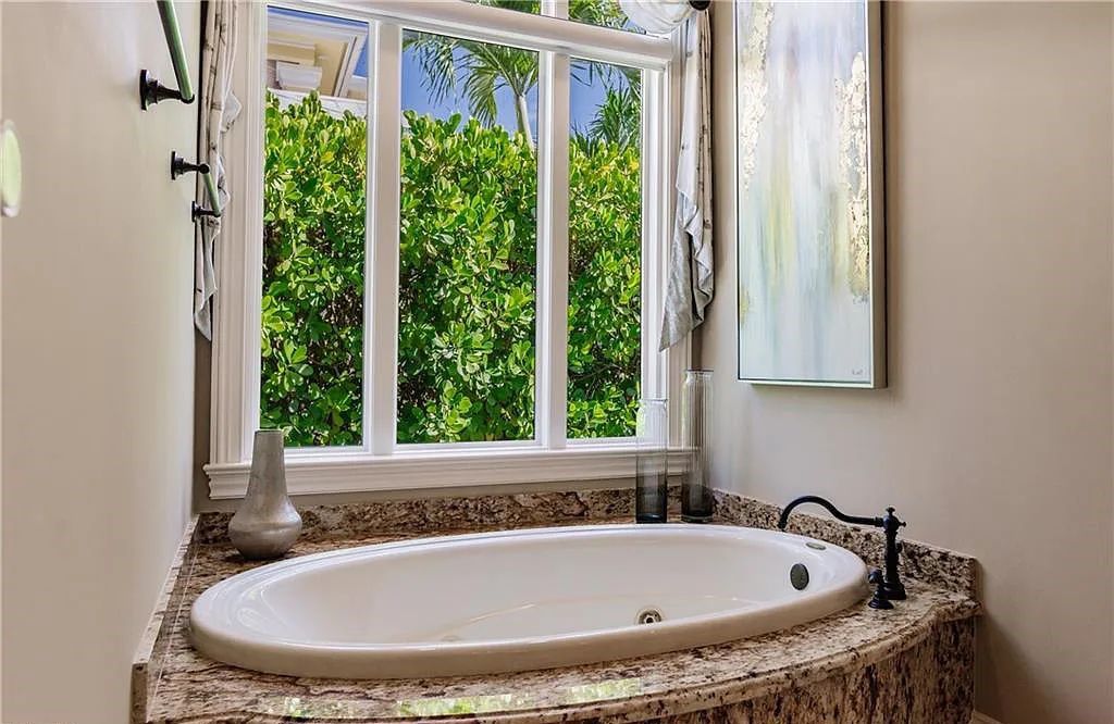 Discover the ultimate Naples, Florida retreat at 2450 Tarpon Road, "The Gateway to Naples Bay." This exceptional property offers a luxurious 4+den/4.5 bath home with 4,450 square feet of living space, recently re-decorated and furnished by Clive Daniel