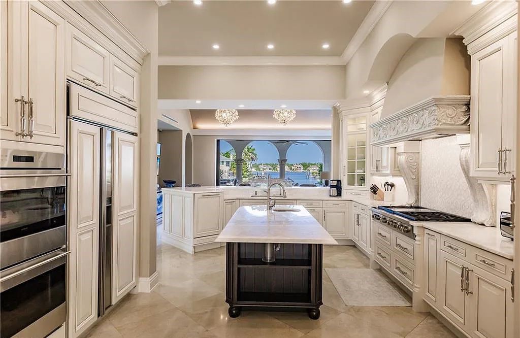 Discover the ultimate Naples, Florida retreat at 2450 Tarpon Road, "The Gateway to Naples Bay." This exceptional property offers a luxurious 4+den/4.5 bath home with 4,450 square feet of living space, recently re-decorated and furnished by Clive Daniel