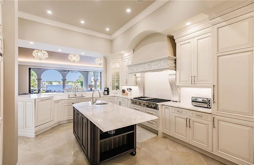 Discover the ultimate Naples, Florida retreat at 2450 Tarpon Road, "The Gateway to Naples Bay." This exceptional property offers a luxurious 4+den/4.5 bath home with 4,450 square feet of living space, recently re-decorated and furnished by Clive Daniel