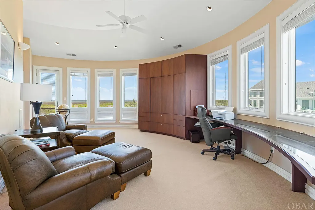 101 Station One Lane Home in Corolla, North Carolina. Discover a remarkable beachfront home with panoramic water views in the prestigious community of Pine Island, Corolla. This stunning coastal retreat offers nine bedrooms with en-suite bathrooms, generous indoor and outdoor amenities, and direct access to 250 feet of secluded beach. 