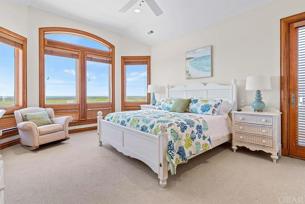 101 Station One Lane Home in Corolla, North Carolina. Discover a remarkable beachfront home with panoramic water views in the prestigious community of Pine Island, Corolla. This stunning coastal retreat offers nine bedrooms with en-suite bathrooms, generous indoor and outdoor amenities, and direct access to 250 feet of secluded beach. 