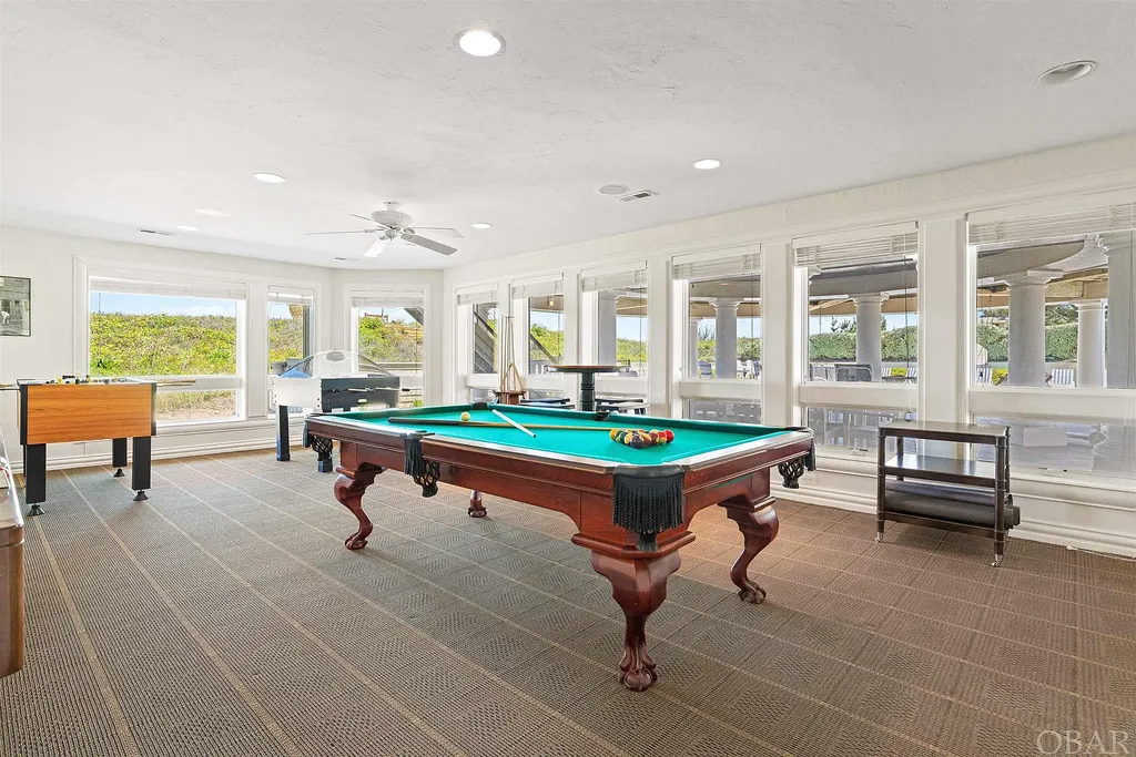 101 Station One Lane Home in Corolla, North Carolina. Discover a remarkable beachfront home with panoramic water views in the prestigious community of Pine Island, Corolla. This stunning coastal retreat offers nine bedrooms with en-suite bathrooms, generous indoor and outdoor amenities, and direct access to 250 feet of secluded beach. 