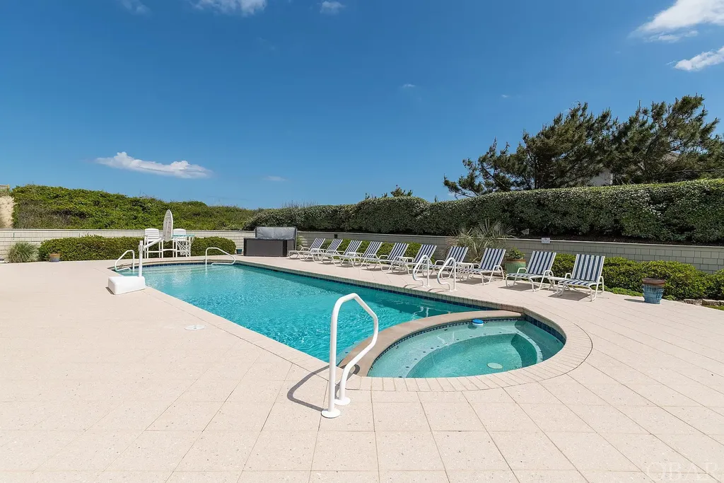 101 Station One Lane Home in Corolla, North Carolina. Discover a remarkable beachfront home with panoramic water views in the prestigious community of Pine Island, Corolla. This stunning coastal retreat offers nine bedrooms with en-suite bathrooms, generous indoor and outdoor amenities, and direct access to 250 feet of secluded beach. 