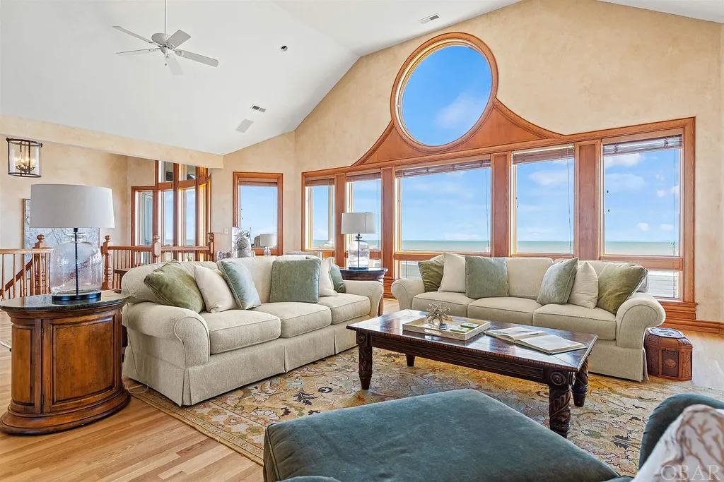 101 Station One Lane Home in Corolla, North Carolina. Discover a remarkable beachfront home with panoramic water views in the prestigious community of Pine Island, Corolla. This stunning coastal retreat offers nine bedrooms with en-suite bathrooms, generous indoor and outdoor amenities, and direct access to 250 feet of secluded beach. 