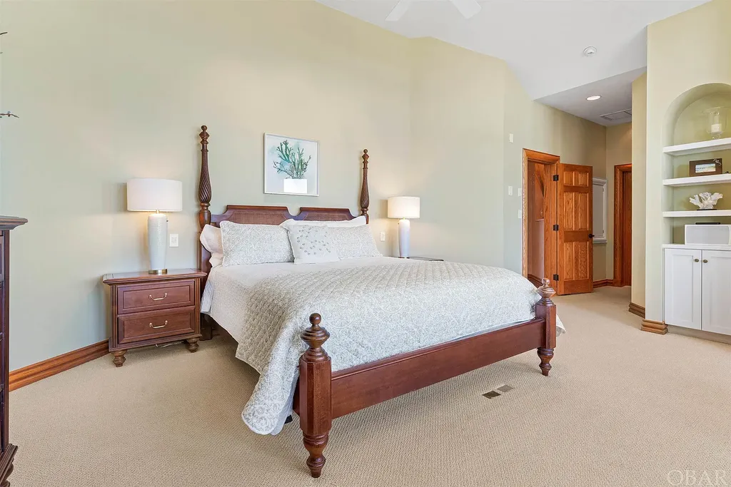 101 Station One Lane Home in Corolla, North Carolina. Discover a remarkable beachfront home with panoramic water views in the prestigious community of Pine Island, Corolla. This stunning coastal retreat offers nine bedrooms with en-suite bathrooms, generous indoor and outdoor amenities, and direct access to 250 feet of secluded beach. 