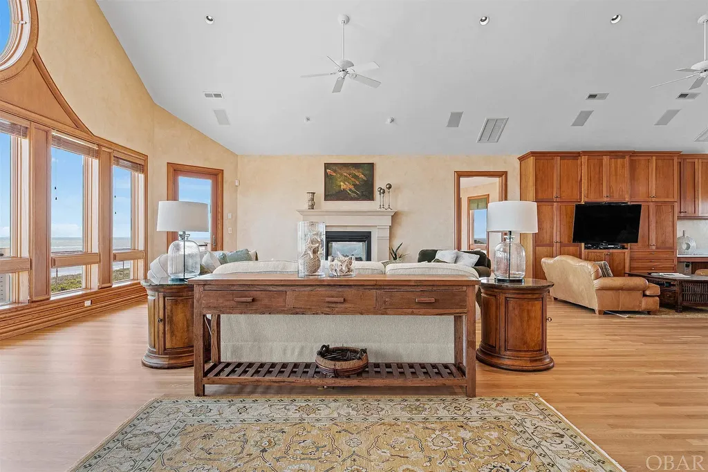 101 Station One Lane Home in Corolla, North Carolina. Discover a remarkable beachfront home with panoramic water views in the prestigious community of Pine Island, Corolla. This stunning coastal retreat offers nine bedrooms with en-suite bathrooms, generous indoor and outdoor amenities, and direct access to 250 feet of secluded beach. 