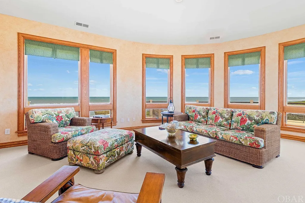 101 Station One Lane Home in Corolla, North Carolina. Discover a remarkable beachfront home with panoramic water views in the prestigious community of Pine Island, Corolla. This stunning coastal retreat offers nine bedrooms with en-suite bathrooms, generous indoor and outdoor amenities, and direct access to 250 feet of secluded beach. 