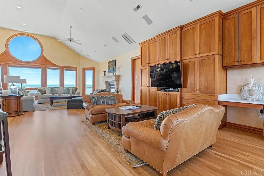 101 Station One Lane Home in Corolla, North Carolina. Discover a remarkable beachfront home with panoramic water views in the prestigious community of Pine Island, Corolla. This stunning coastal retreat offers nine bedrooms with en-suite bathrooms, generous indoor and outdoor amenities, and direct access to 250 feet of secluded beach. 