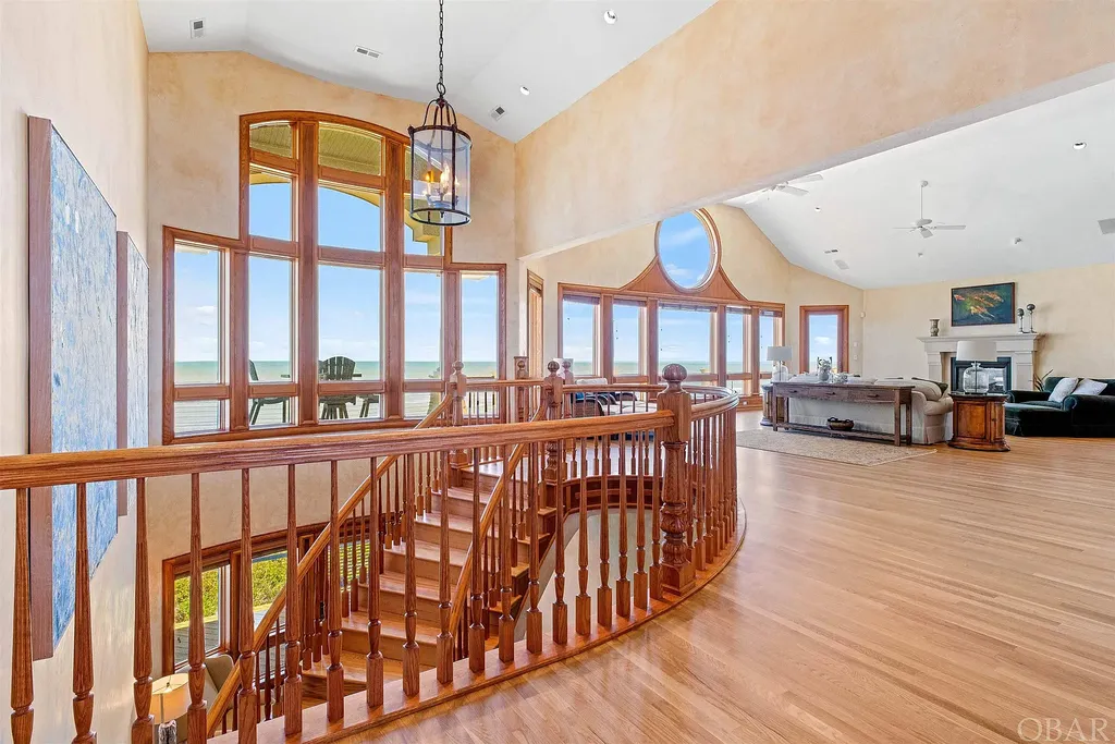 101 Station One Lane Home in Corolla, North Carolina. Discover a remarkable beachfront home with panoramic water views in the prestigious community of Pine Island, Corolla. This stunning coastal retreat offers nine bedrooms with en-suite bathrooms, generous indoor and outdoor amenities, and direct access to 250 feet of secluded beach. 