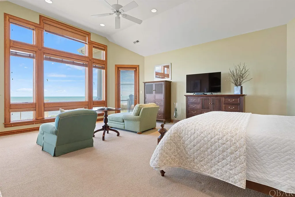 101 Station One Lane Home in Corolla, North Carolina. Discover a remarkable beachfront home with panoramic water views in the prestigious community of Pine Island, Corolla. This stunning coastal retreat offers nine bedrooms with en-suite bathrooms, generous indoor and outdoor amenities, and direct access to 250 feet of secluded beach. 