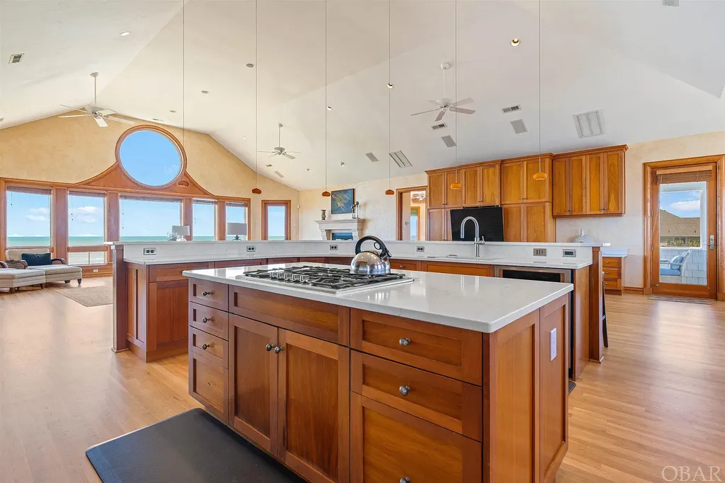101 Station One Lane Home in Corolla, North Carolina. Discover a remarkable beachfront home with panoramic water views in the prestigious community of Pine Island, Corolla. This stunning coastal retreat offers nine bedrooms with en-suite bathrooms, generous indoor and outdoor amenities, and direct access to 250 feet of secluded beach. 