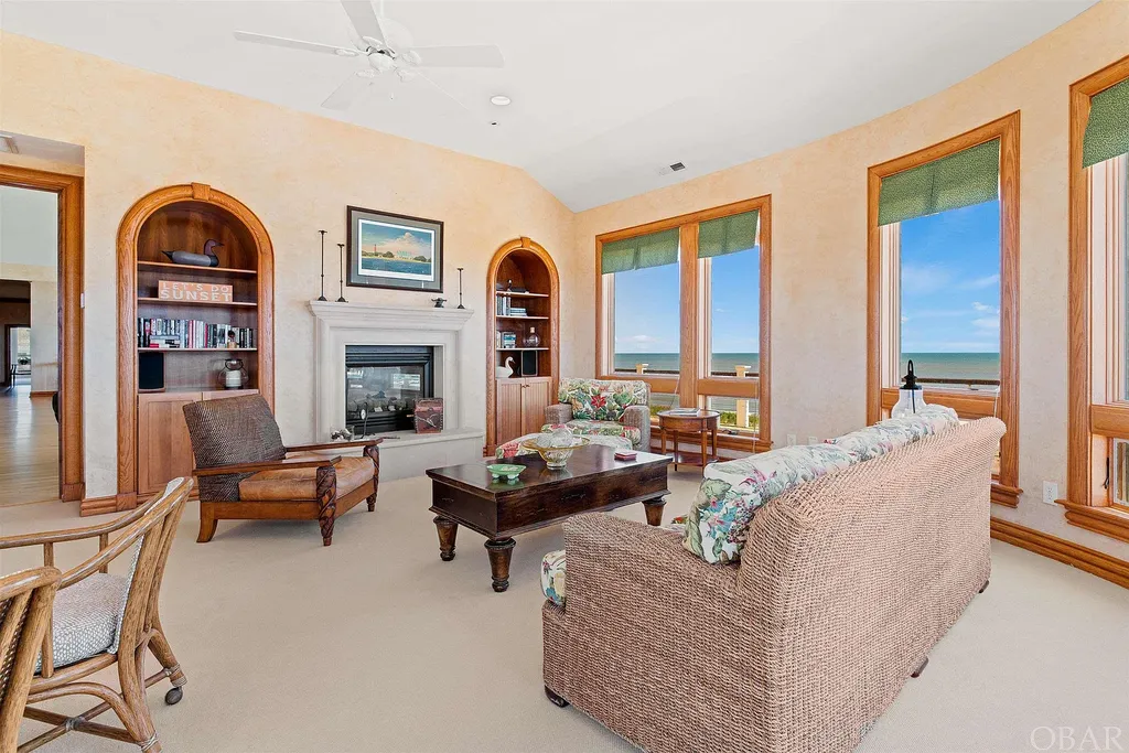 101 Station One Lane Home in Corolla, North Carolina. Discover a remarkable beachfront home with panoramic water views in the prestigious community of Pine Island, Corolla. This stunning coastal retreat offers nine bedrooms with en-suite bathrooms, generous indoor and outdoor amenities, and direct access to 250 feet of secluded beach. 