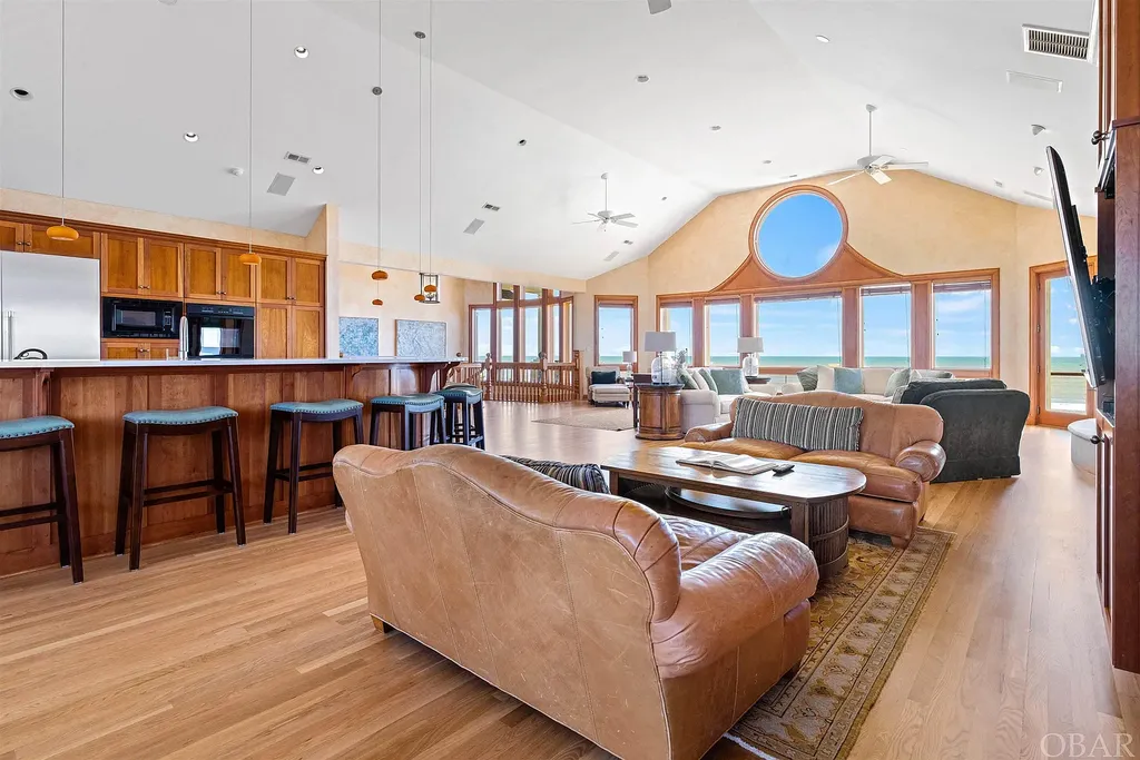 101 Station One Lane Home in Corolla, North Carolina. Discover a remarkable beachfront home with panoramic water views in the prestigious community of Pine Island, Corolla. This stunning coastal retreat offers nine bedrooms with en-suite bathrooms, generous indoor and outdoor amenities, and direct access to 250 feet of secluded beach. 