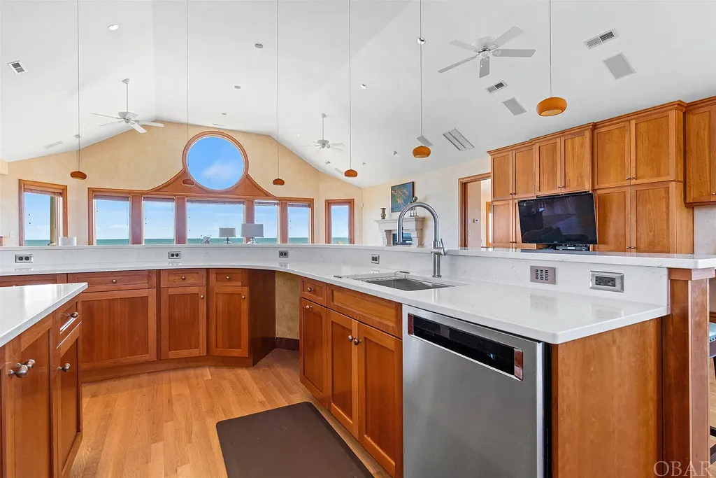 101 Station One Lane Home in Corolla, North Carolina. Discover a remarkable beachfront home with panoramic water views in the prestigious community of Pine Island, Corolla. This stunning coastal retreat offers nine bedrooms with en-suite bathrooms, generous indoor and outdoor amenities, and direct access to 250 feet of secluded beach. 
